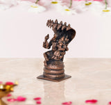 Lakshmi Varaha copper statue side view, stacked base with dark blue-black body