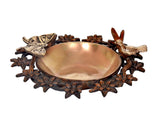 Brass decorative urli bowl with floral leaf base and small bird figures on the rim