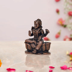Copper Bala Tambika Sundari statue, seated child with ornate jewelry, three-quarter view