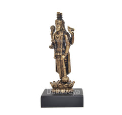 Lord Vishnu idol from a side angle, raised hands and crown detail on black base