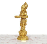 Golden brass Apsara lady holding an oil lamp, side profile figurine