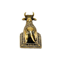 Brass Nandi cow idol back view with horns and tail on decorative base