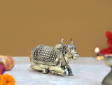 Brass Nandi bull statue with side profile, detailed saddle and decorative swirls