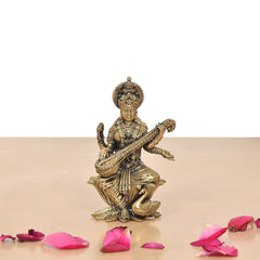 Maa Saraswati brass figurine seated on lotus with veena and raised hands
