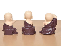 Purple resin monk Buddha figurines from the back, seated, hands at sides