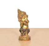 Brass Baby Ganesha sculpture with Meenakari details and patterned base, angled view