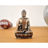 Gold-tone resin Buddha idol, seated with right hand raised on lotus base