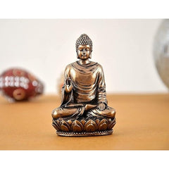 Gold-tone resin Buddha idol, seated with right hand raised on lotus base