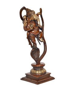 Side view of dancing Lord Ganesha on serpent Shesha idol, brass finish
