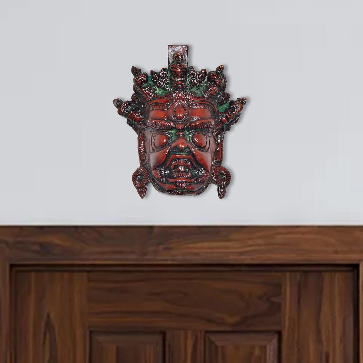 Brass Mahakala wall hanging mask, multicolored, front face with red and green accents