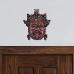 Brass Mahakala wall hanging mask, multicolored, front face with red and green accents