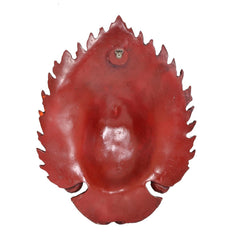 Back of red resin Mahakal wall mask with hanging hook at top center