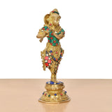 Krishna flute figurine from rear angle, detailed crown and jeweled belt on brass base