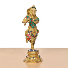 Krishna flute figurine from rear angle, detailed crown and jeweled belt on brass base