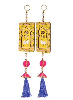 Two Shubh Labh door hangings: yellow tags, pink bead ornament, blue tassel