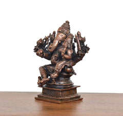 Copper Ganesha idol from the side, seated with Riddhi, ornate standing details