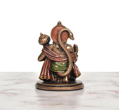 Resin Hanuman JI idol, back view—arched tail and multicolor robe on round base.