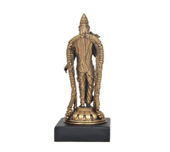 Back view of gold-toned deity idol statue with tiered lotus base and beaded arm bands