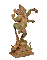 Dancing Ganesha brass statue from angled view, four arms raised over ornate pedestal