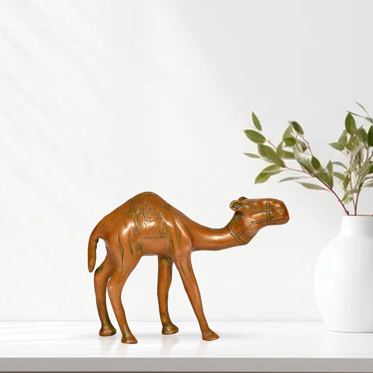 Brass camel figurine, 6-inch height, embossed body details, arched neck with green accents