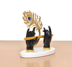 Front view Krishna hands holding flute; black resin, gold peacock frame with blue gem