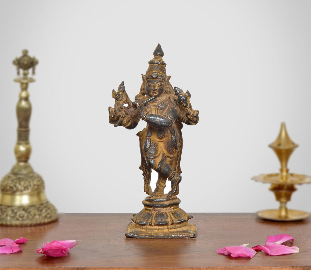 Copper Krishna idol with four arms, ornate crown and standing base