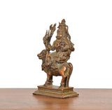 Copper Shiva Parvati on Nandi statue, angled view with raised hand and trident