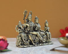 Brass Shiv Parivar idol, side view: Shiva seated with three dressed devotees beside