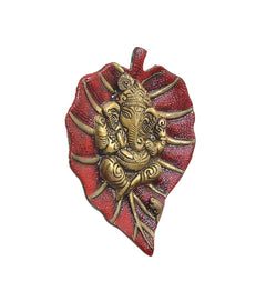 Metal Ganesha wall hanging angled view, heart-shaped red and gold relief figure