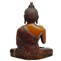 Seated brass Buddha idol from behind, ornate back detailing and patterned base