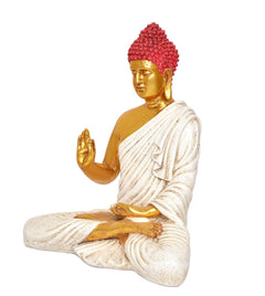 Seated Buddha statue side view, red crown, gold face, white robe, raised blessing hand