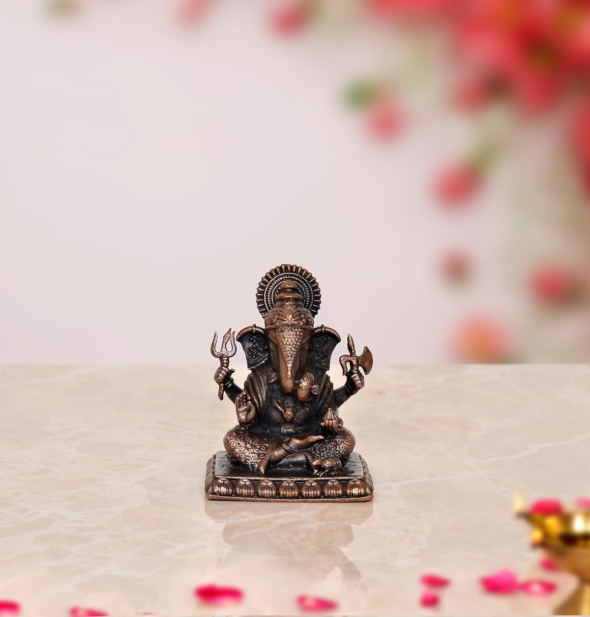 Copper Ganesha idol statue with multicolor detailing on seated Vinayak figure