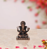 Copper Ganesha idol statue with multicolor detailing on seated Vinayak figure