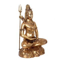 Brass Shiva statue seated in yoga pose, tall trident and layered necklaces, lion base