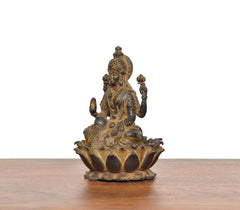 Copper Lakshmi idol from rear angle, detailed back drapery on seated lotus base