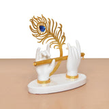 Angle view: white resin Krishna hands and gold flute with blue peacock motif, white base