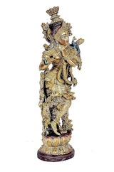 Brass Krishna idol playing flute, close side profile with intricate crown and ornaments