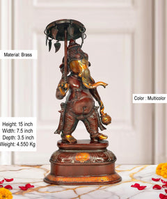 Brass Ganesha statue holding a parasol, multicolored detailing on decorated base