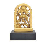 Golden brass Durga idol, detailed arched back with figure, on black base.