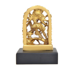 Golden brass Durga idol, detailed arched back with figure, on black base.