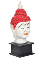 Resin Buddha head statue three-quarter view, red beaded crown, black base
