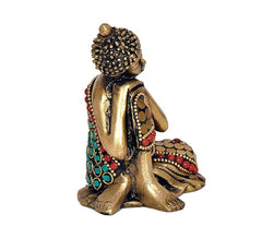 Brass Gautam Buddha statue idol side view, teal and red decorative accents on robe