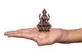 Copper Lakshmi idol statue held in hand for scale, seated on lotus base