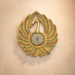 Brass peacock wall hanging with red, green, and gold gem details and bell ornament