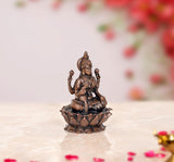 Copper Lakshmi idol statue, three-quarter view with crown and four-armed hand positions