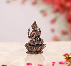 Copper Lakshmi idol statue, three-quarter view with crown and four-armed hand positions