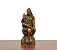 Front view brass Shirdi Sai Baba statue seated with blessing hand raised
