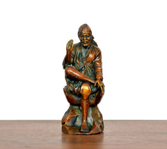 Front view brass Shirdi Sai Baba statue seated with blessing hand raised