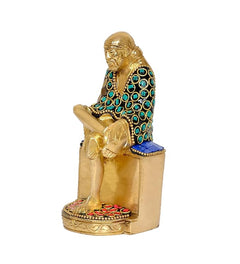 Brass Shirdi Sai Baba statue idol, side view showing seated legs and jeweled robe