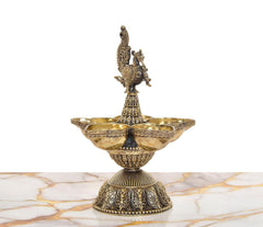 Ornate brass peacock oil lamp stand with five diya holders, detailed pedestal